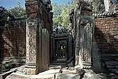 Ta Prohm temple - the badly ruined gopura of the gallery first found entering the site from west